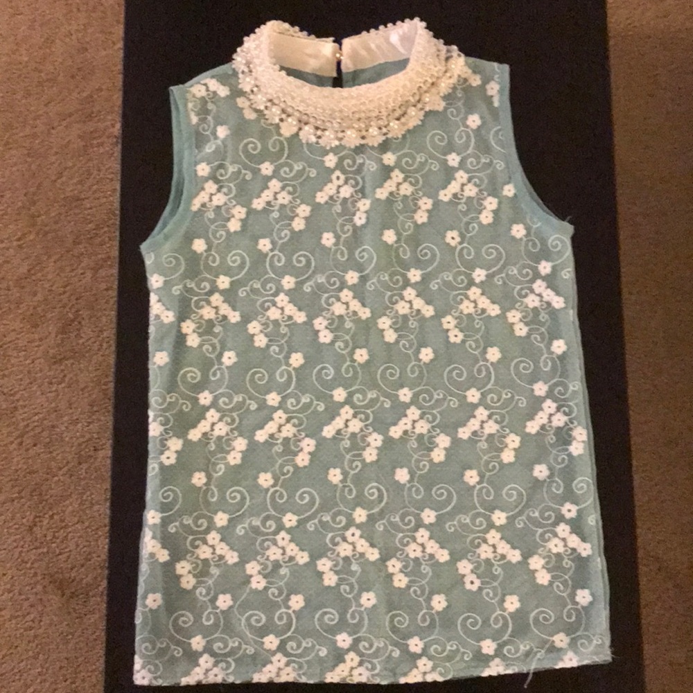 Beautiful sleeveless blouse with faux pearls